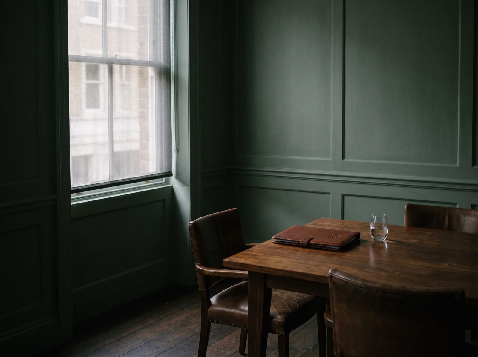 A private meeting room set for two, morning light across the table